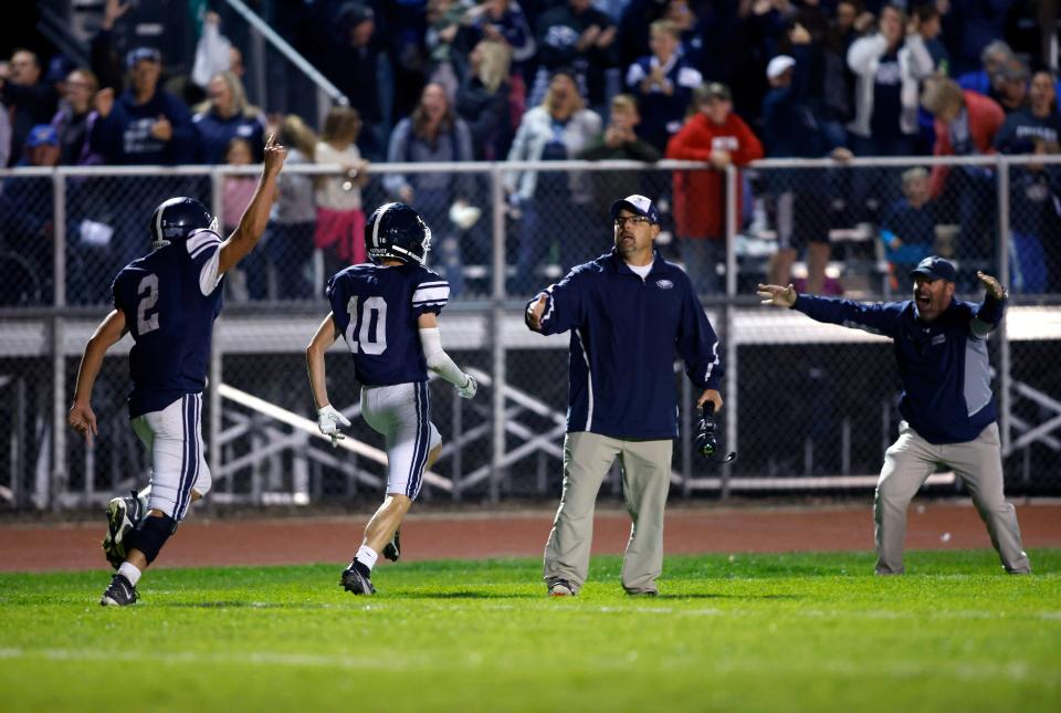 Fowler's Nolan Stump (2) and Ben Kohagen (10) and head coach John Spicer react after Kohagen scored the game-winning touchdown against Pewamo-Westphalia, Friday, Sept. 23, 2022, in Fowler. Fowler won 20-16.