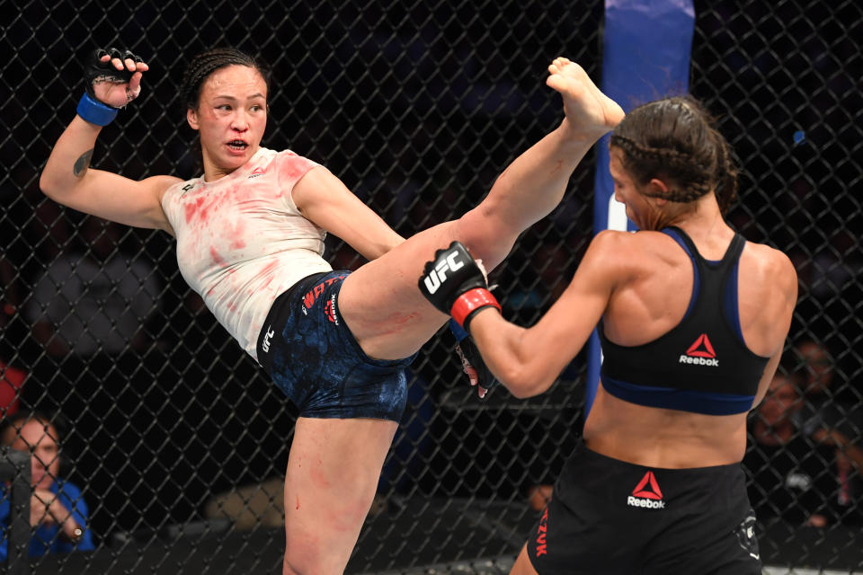 TAMPA, FLORIDA - OCTOBER 12: (L-R) Michelle Waterson kicks Joanna Jedrzejczyk of Poland in their women's strawweight bout during the UFC Fight Night event at Amalie Arena on October 12, 2019 in Tampa, Florida. (Photo by Josh Hedges/Zuffa LLC via Getty Images)