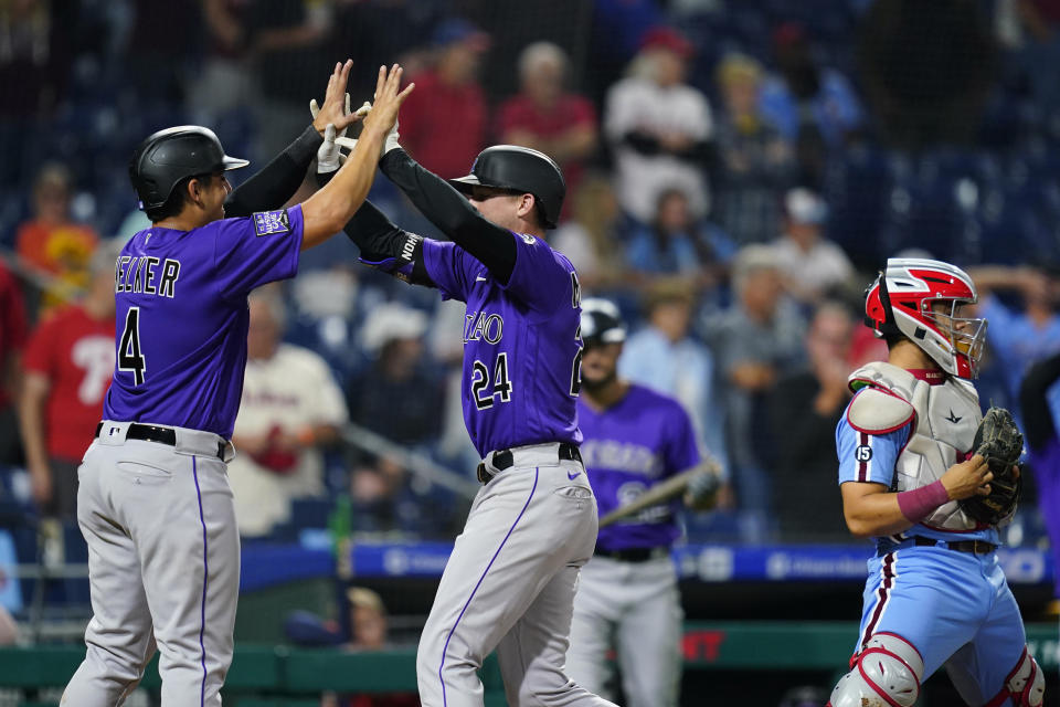 Colorado Rockies' Colton Welker, left, and Ryan McMahon, center, celebrate after McMahon's two-run home run against Philadelphia Phillies pitcher Ian Kennedy during the ninth inning of a baseball game, Thursday, Sept. 9, 2021, in Philadelphia. (AP Photo/Matt Slocum)