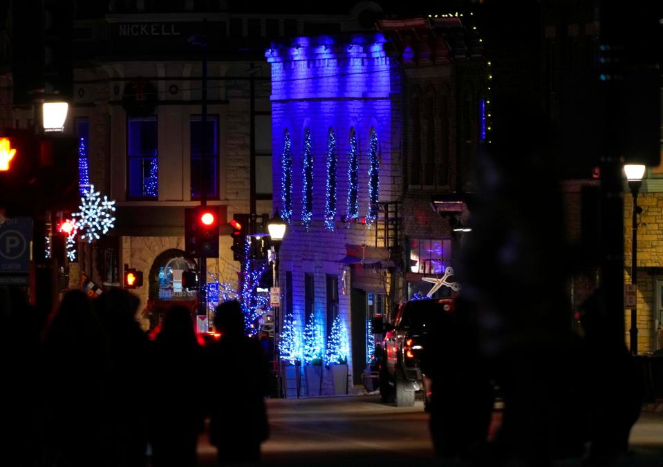 A business is lit up in blue in downtown Waukesha as a sign of solidarity during the one-year anniversary of the Christmas Parade tragedy at Cutler Park in Waukesha on Monday, Nov. 21, 2022.