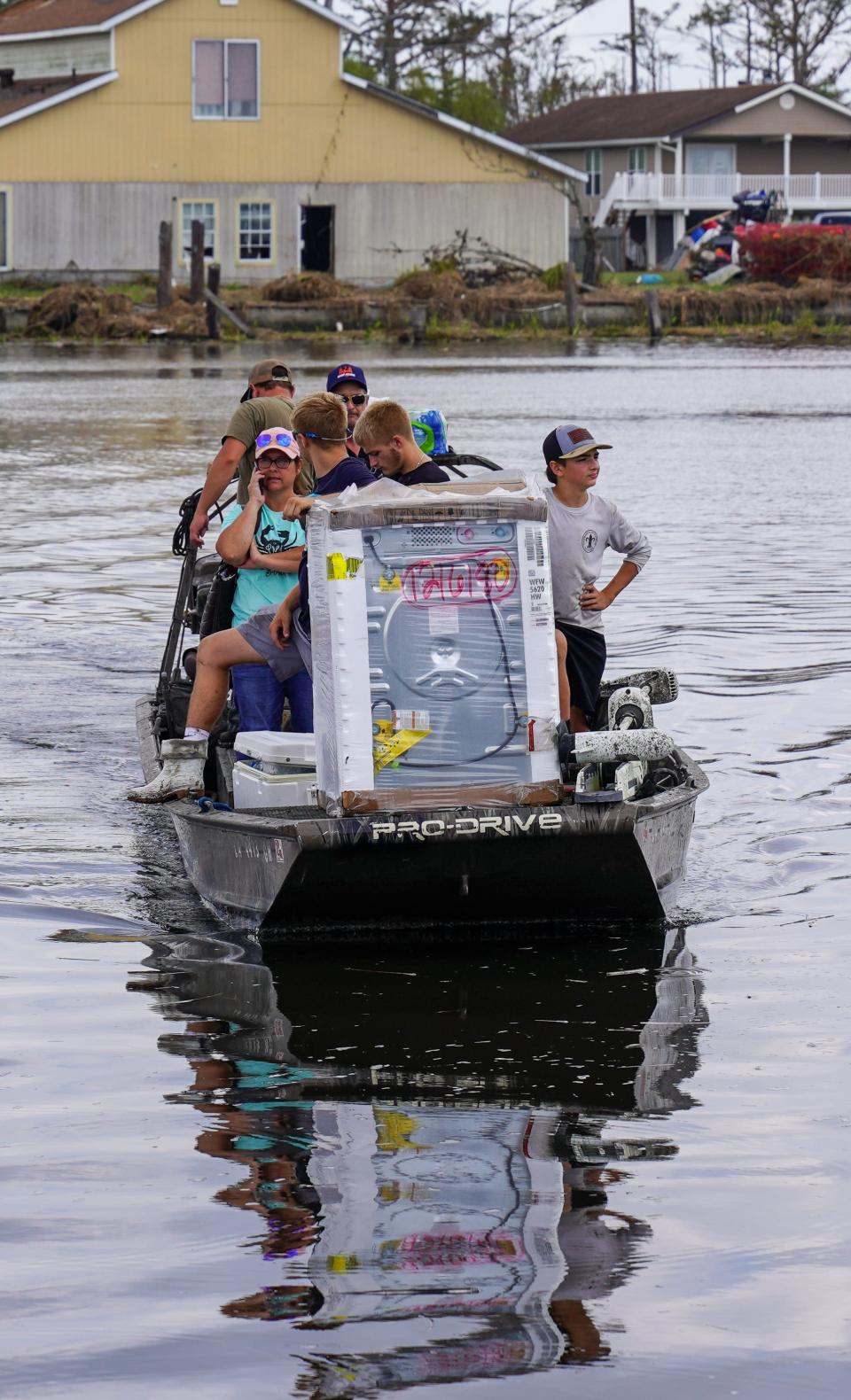 Tess Coulon's team rides to her hometown island of Barataria, La., which was cut off from the mainland by Hurricane Ida. Coulon's washing machine broke after the storm, and she traveled to the mainland to get a new one, so she and her family could have clean clothes while they wait for the road to be repaired.