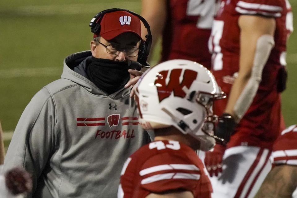 Wisconsin head coach Paul Chryst talks to players during the first half of an NCAA college football game against Illinois Friday, Oct. 23, 2020, in Madison, Wis. (AP Photo/Morry Gash)
