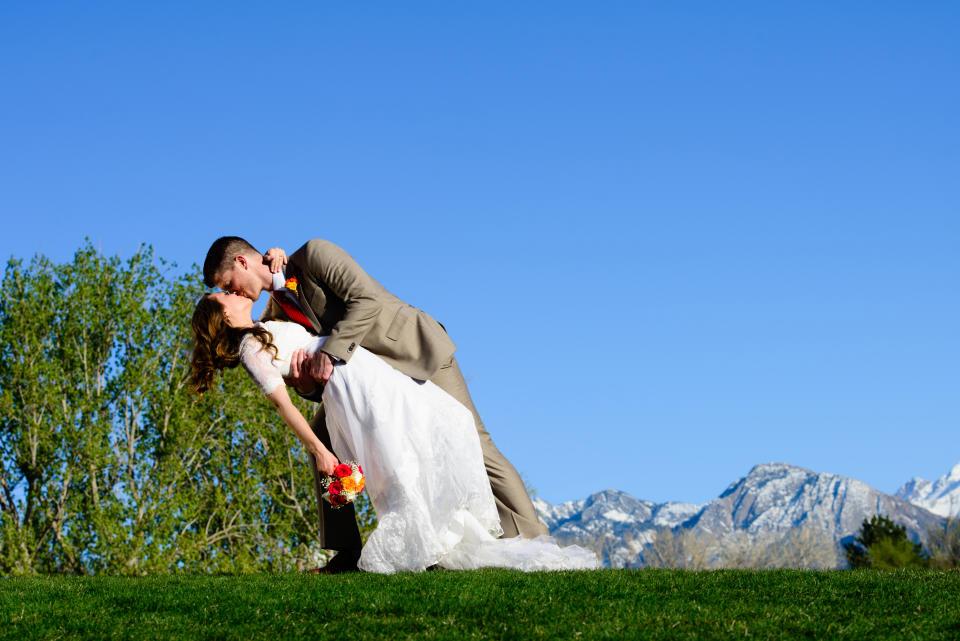 A bride and groom doing a dip kiss