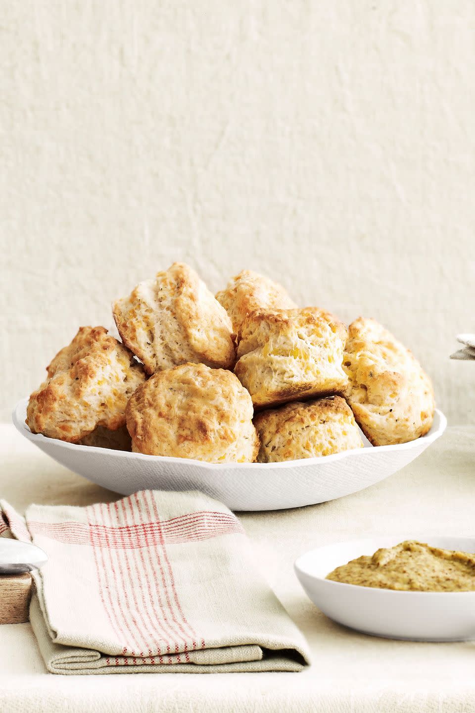 <p>These savory biscuits are the perfect starter to your meal.</p><p><strong><a href="https://www.countryliving.com/food-drinks/recipes/a4268/cheddar-biscuits-recipe-clv1212/" rel="nofollow noopener" target="_blank" data-ylk="slk:Get the recipe;elm:context_link;itc:0;sec:content-canvas" class="link ">Get the recipe</a>.</strong> </p>