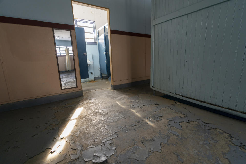 The woman's changing area at the Spratt Park pool house in Poughkeepsie, N.Y., is in need of repair, on Tuesday, Jan. 25, 2022. Poughkeepsie was rated by the New York comptroller as the state’s most financially stressed community in 2020. The more than $20 million it is getting from the American Rescue Plan cannot be used to wipe out the deficit, but the city plans to make major improvements to parks and swimming pools, including a complete rebuild of a run-down bathhouse that has been relying on portable toilets. (AP Photo/Mary Altaffer)