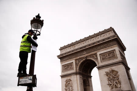 A protester wearing a yellow vest takes part in a demonstration by the "yellow vests" movement near the Arc de Triomphe in Paris, France, January 12, 2019. REUTERS/Christian Hartmann