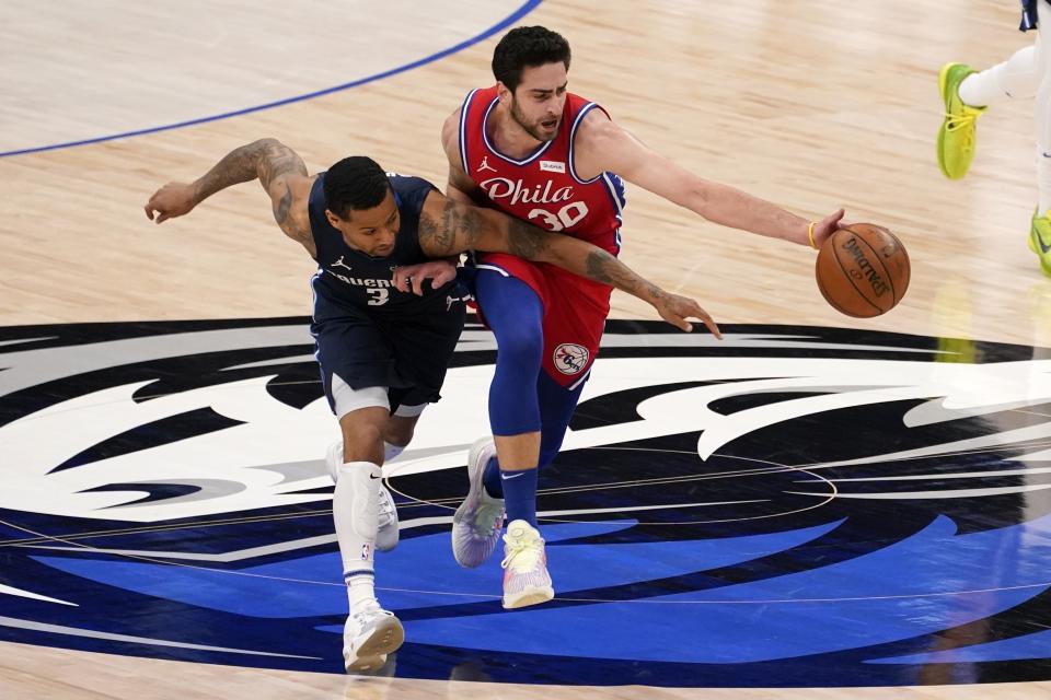 Dallas Mavericks guard Trey Burke (3) competes against Philadelphia 76ers guard Furkan Korkmaz (30) for control of a loose ball in the second half of an NBA basketball game in Dallas, Monday, April 12, 2021. (AP Photo/Tony Gutierrez)