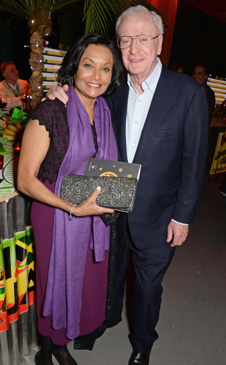 Michael Caine (R) and wife Shakira Caine attend "A Night of Reggae" hosted by Helena Bonham Carter for Save The Children UK at The Roundhouse on March 12, 2014 in London, England