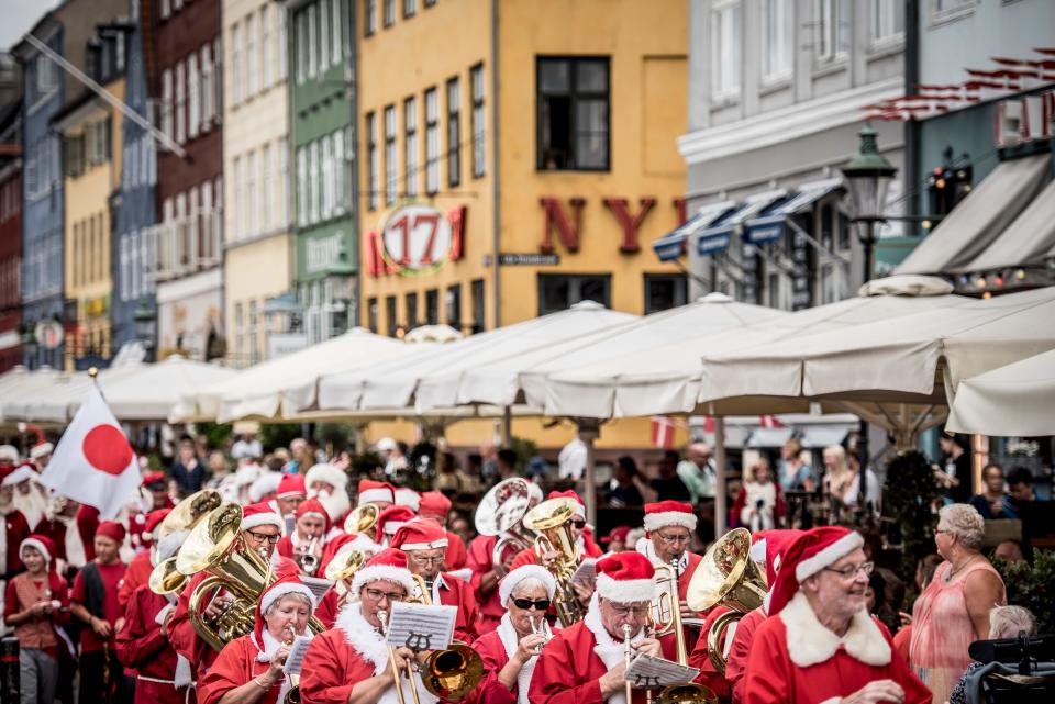 <p>People dressed as Santa Claus and elves take part in a street parade that is part of the annual World Santa Claus congress on July 23, 2018 in Copenhagen. (Photo: Mads Claus Rasmussen/Ritzau Scanpix/AFP/Getty Images) </p>