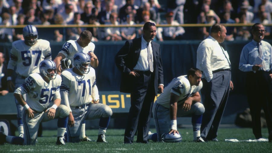 Coach George Wilson and the Lions look on from the bench during a 1961 game.