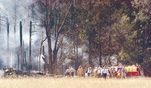 In this Daily American file photo, first responders examine the site where Flight 93 went down in Shanksville on Sept. 11, 2001.