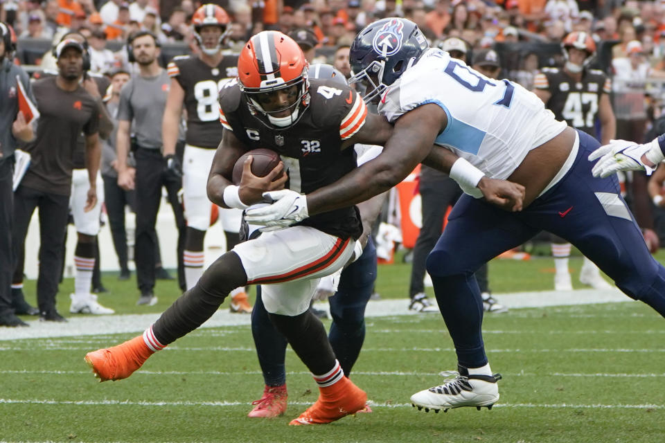 Cleveland Browns quarterback Deshaun Watson (4) is tackled by Tennessee Titans defensive tackle Teair Tart, right, during the second half of an NFL football game Sunday, Sept. 24, 2023, in Cleveland. (AP Photo/Sue Ogrocki)