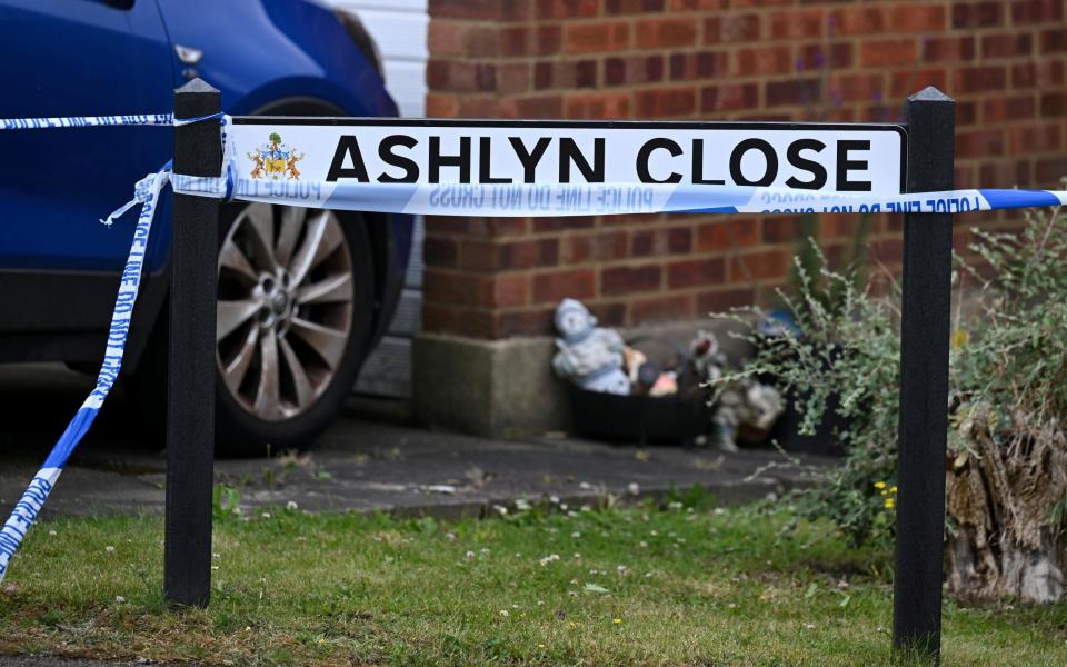 A police cordon is in place at the scene of a triple murder in Ashlyn Close