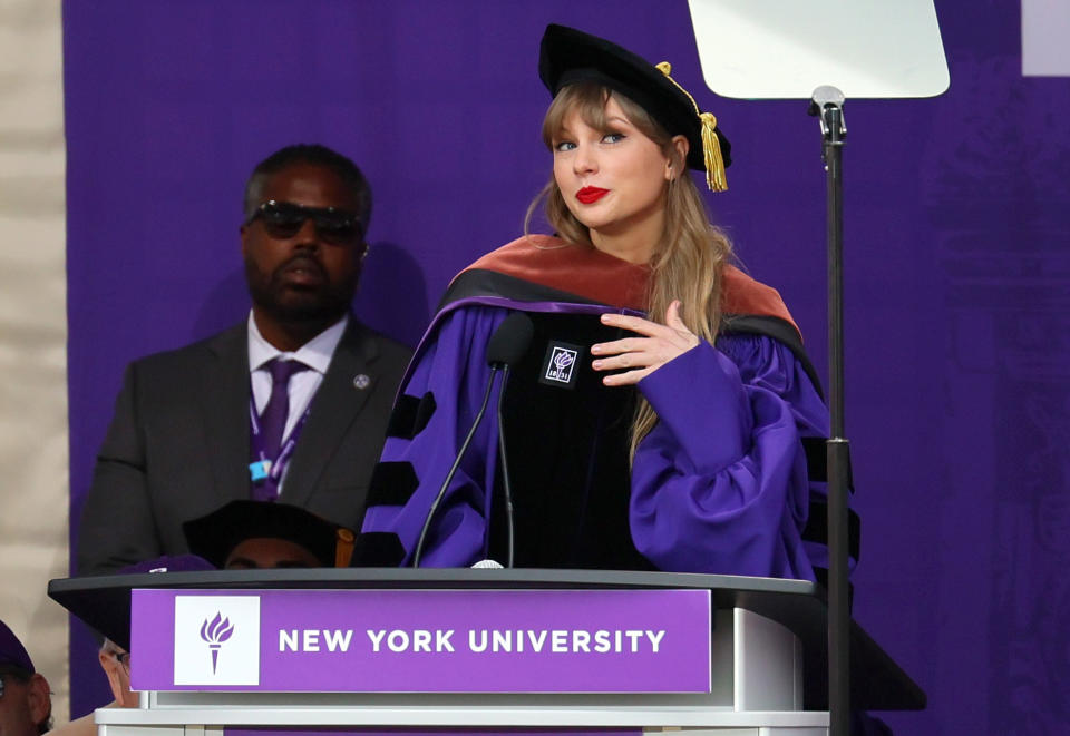 Taylor at the podium smiling