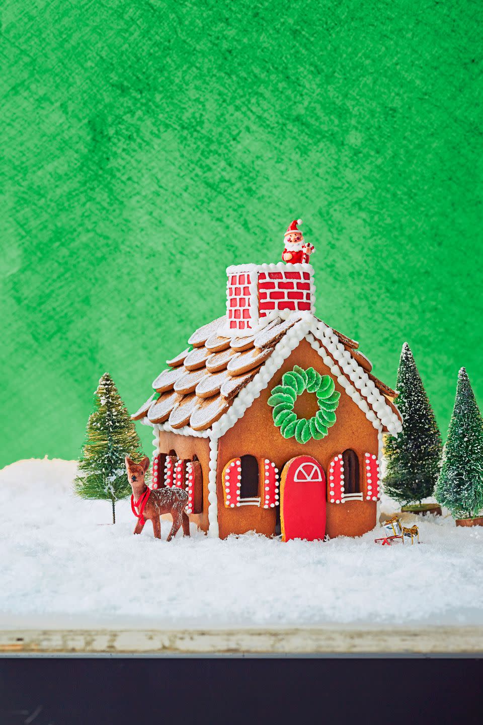 <p>Gingersnap cookies make for delicious shingles! Surround your creation with coconut "snow" and bottlebrush trees to create a cute holiday display.</p>