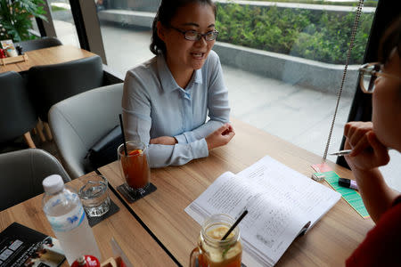 Chinese national Cherry He Ting (L) teaches a student in a coffee shop in Bangkok, Thailand, November 18, 2018. Picture taken November 18, 2018. REUTERS/Soe Zeya Tun