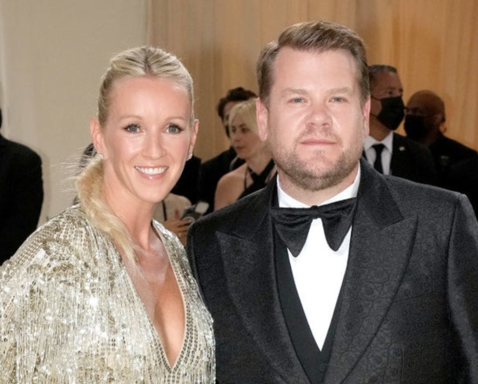 A close up of Julia Carey and James Corden as they pose for the camera