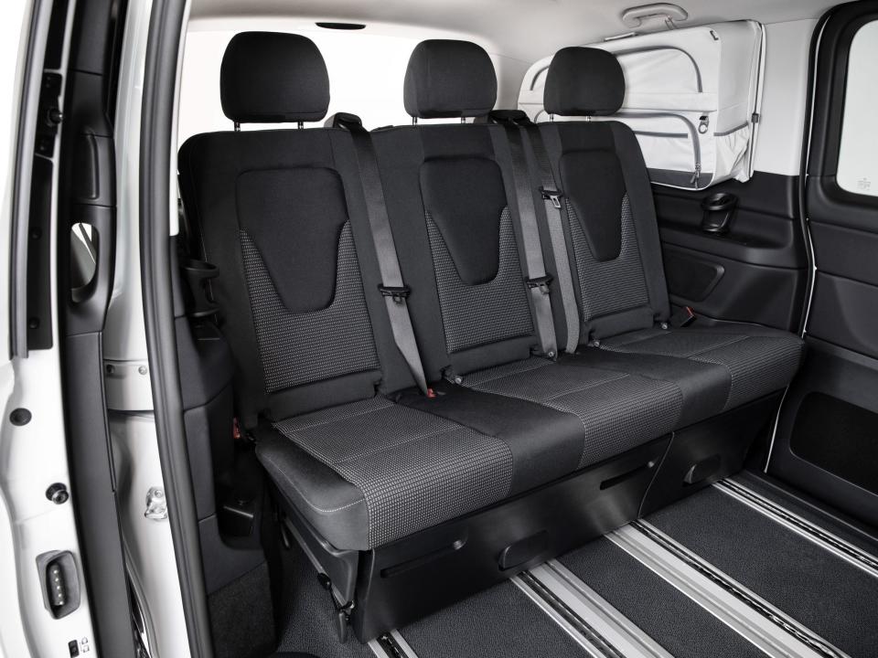 A row of three seats inside a van.