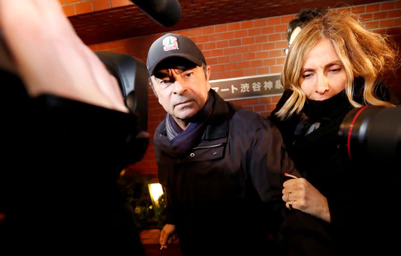 Former Nissan Motor Chairman Carlos Ghosn accompanied by his wife Carole Ghosn, arrives at his place of residence in Tokyo