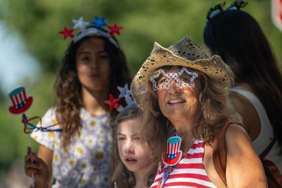 Roslyn Jacobs, of Folsom, Georgia Jacobs, center, and Zoey Long, left, watch the Folsom’s annual parade on Sutter Street on Saturday.