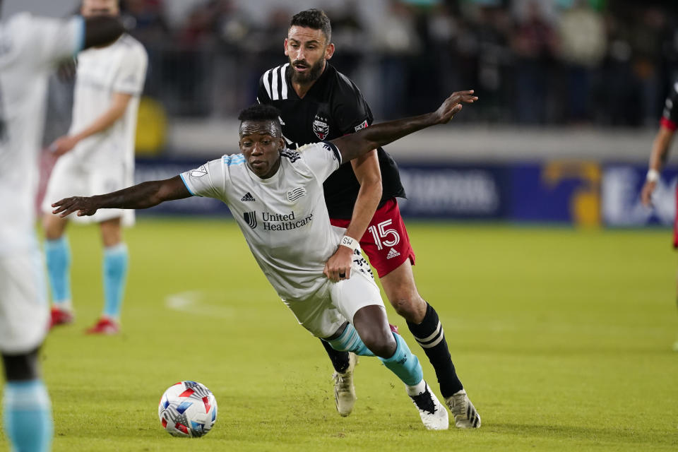 New England Revolution midfielder Luis Caicedo (27) and D.C. United defender Steve Birnbaum (15) battle for the ball during the second half of an MLS soccer match, Wednesday, Oct. 20, 2021, in Washington. The Revolution won 3-2. (AP Photo/Alex Brandon)