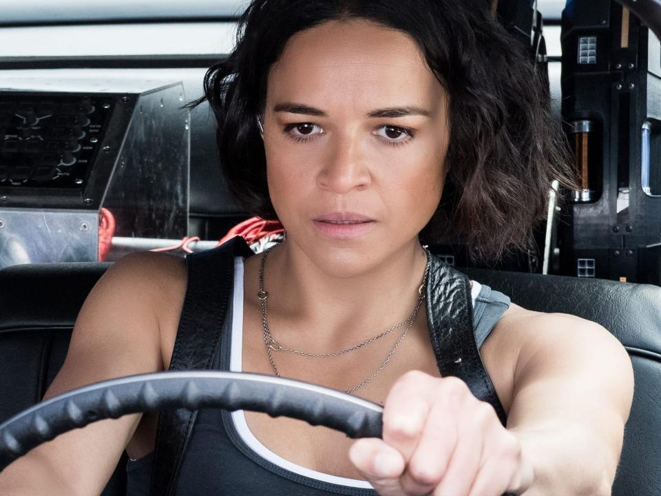 Nathalie Emmanuel's Ramsey looking at Michelle Rodriguez's Letty behind the wheel of a vehicle in "Fast and Furious 9."