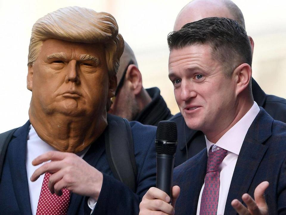 Tommy Robinson with a supporter dressed as Donald Trump addressing a crowd outside the Old Bailey from a stage on 23 October (AFP/Getty Images)