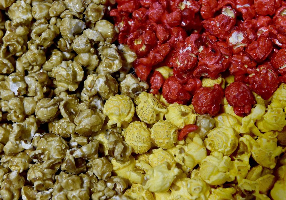 Topsy’s popcorn factory in the Waldo neighborhood is busy filling holiday cans. Caramel (from left, clockwise) cinnamon and cheese popcorn. Jill Toyoshiba/jtoyoshiba@kcstar.com