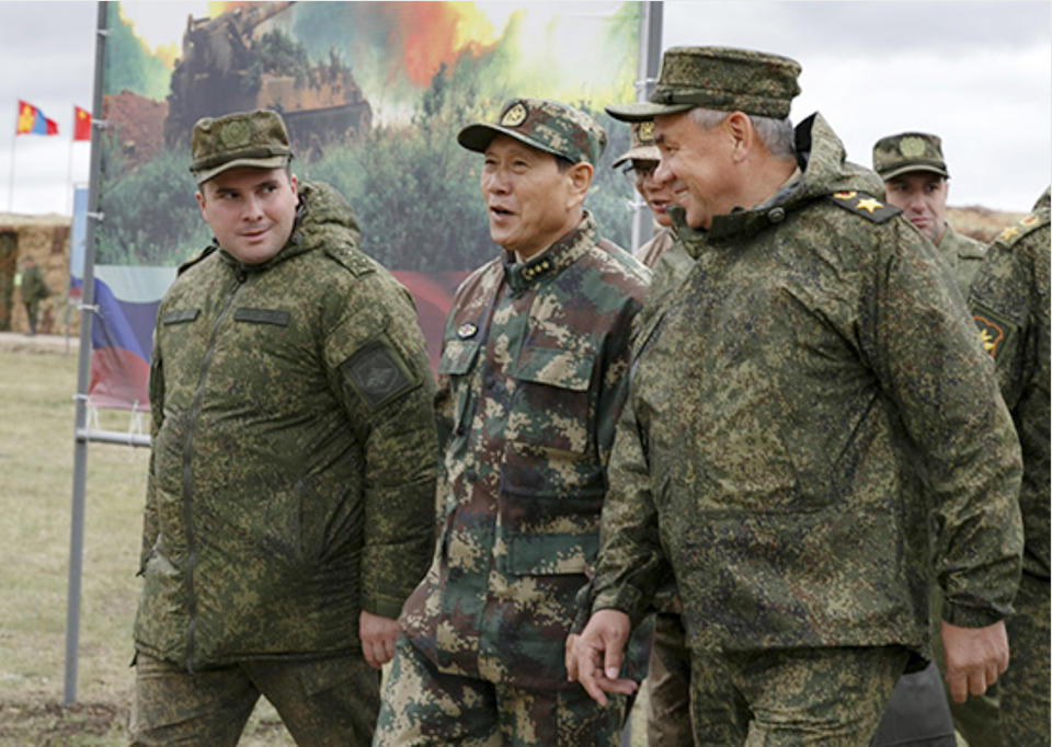 In this photo provided by Russian Defense Ministry Press Service on Wednesday, Sept. 12, 2018, Russian Defense Minister Sergei Shoigu, right, and his Chinese counterpart, Gen. Wei Fenghe, center, visit the Tsugol firing range in eastern Siberia where nearly 300,000 Russian troops and about 3,200 Chinese troops are participating in joint exercises. (Russian Defense Ministry Press Service pool photo via AP)