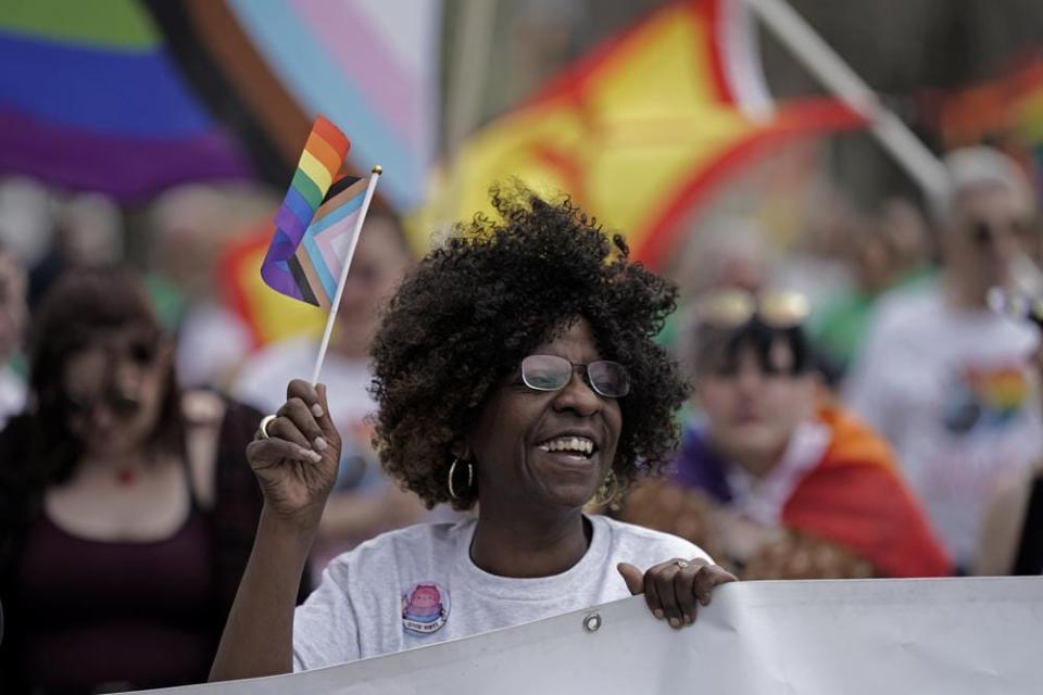 Teresa Parks walks in the Little Apple Pride parade Saturday, April 23, 2022, in Manhattan, Kan. (AP Photo/Charlie Riedel)