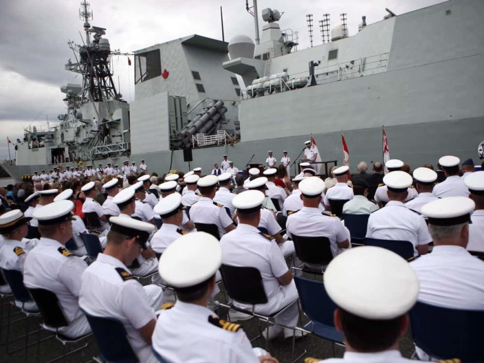 Sailors attend a change of command ceremony at CFB Esquimalt, in Esquimalt, B.C. on June 24, 2015. HMCS Calgary is in the background. (Chap Hipolito/The Canadian Press - image credit)
