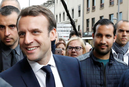 Emmanuel Macron (L), head of the political movement En Marche !, or Onwards !, and candidate for the 2017 presidential election, flanked by Alexandre Benalla (R), head of security, attends a campaign visit in Rodez, France, May 5, 2017. Picture taken May 5, 2017 . REUTERS/Regis Duvignau