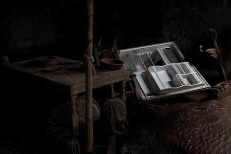 A refrigerator lies inside a kitchen of a house affected by the eruption of the Fuego volcano at San Miguel Los Lotes in Escuintla, Guatemala, June 8, 2018. REUTERS/Carlos Jasso