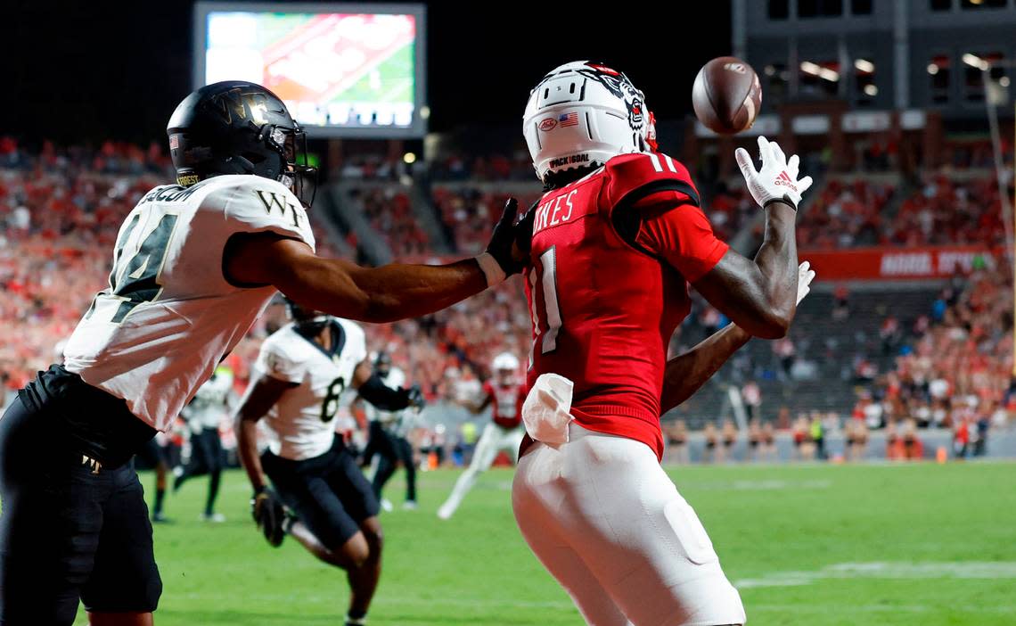 N.C. State wide receiver Darryl Jones (11) pulls in a 13-yard touchdown reception as Wake Forest defensive back Evan Slocum (14) defends during the first half of N.C. State’s game against Wake Forest at Carter-Finley Stadium in Raleigh, N.C., Saturday, Nov. 5, 2022.