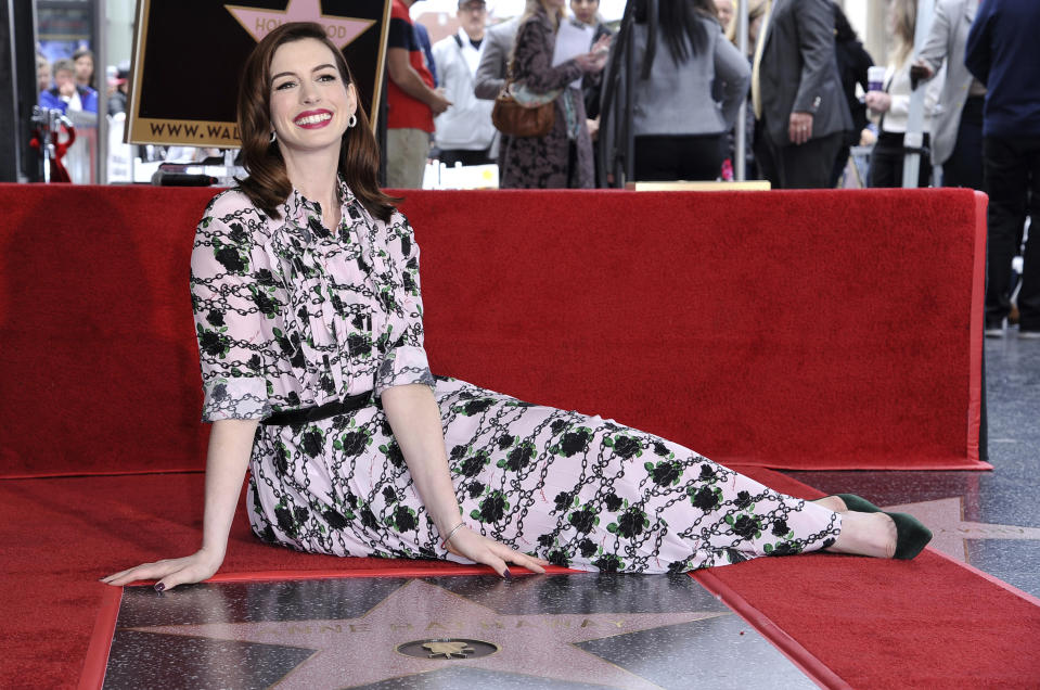 FILE - Anne Hathaway poses atop her new star on the Hollywood Walk of Fame following a ceremony in her honor on May 9, 2019, in Los Angeles. Hathaway turns 39 on Nov. 12. (Photo by Richard Shotwell/Invision/AP, File)