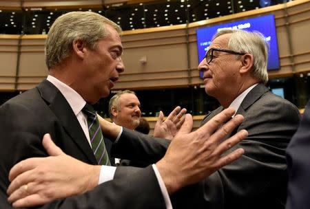 European Commission President Jean-Claude Juncker welcomes Nigel Farage, the leader of the United Kingdom Independence Party, prior to a plenary session at the European Parliament on the outcome of the "Brexit" in Brussels, Belgium, June 28, 2016. REUTERS/Eric Vidal