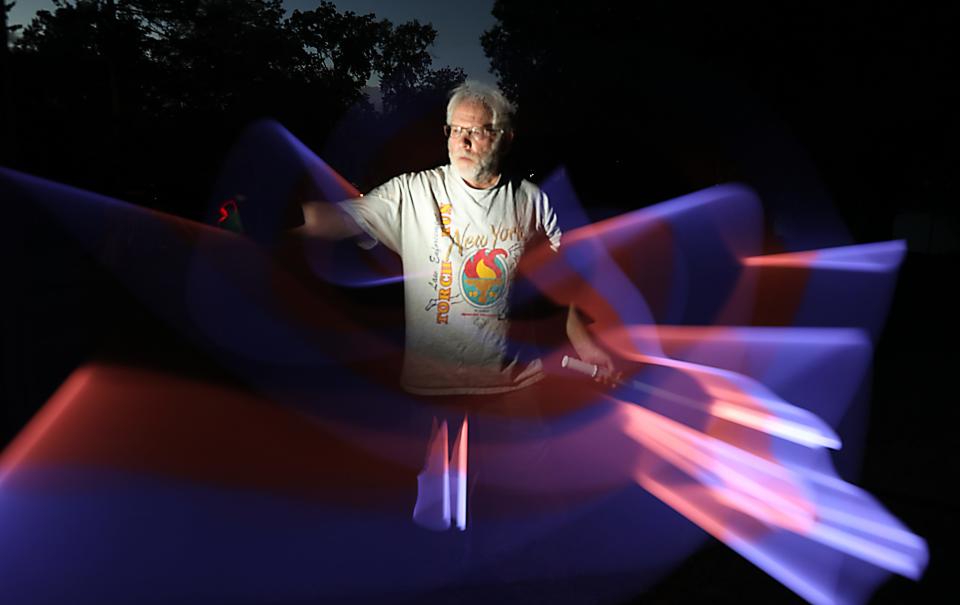 Peter Carr testing light painting techniques to be used in Super 11 Football preview Aug. 8, 2022.