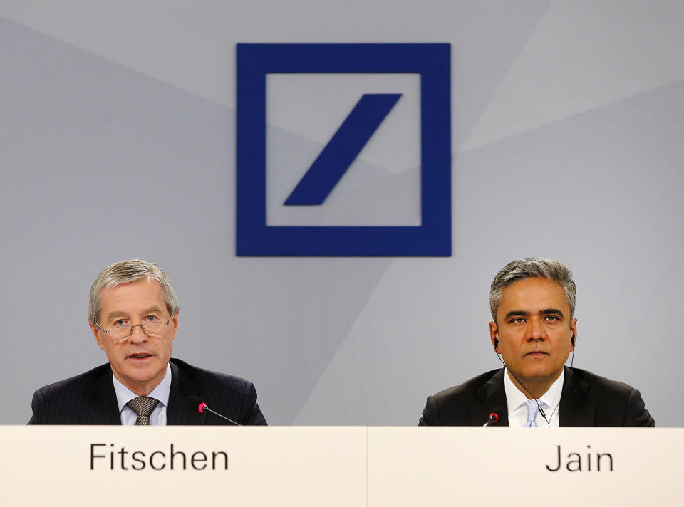 CEOs of Deutsche Bank Anshu Jain, right, and Juergen Fitschen attend the annual press conference in Frankfurt, Germany, Wednesday, Jan. 29, 2014. Germany's biggest bank had a surprise loss of 965 million euros (US dollar 1.32 billion) in the fourth quarter, as earnings were burdened by 528 million in costs for court settlements and investigations into alleged past misconduct in the fourth quarter. (AP Photo/Michael Probst)