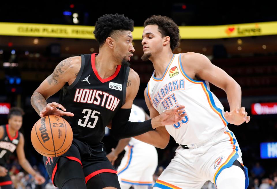 Former Houston Rockets center Christian Wood, left, is defended by Oklahoma City Thunder forward Jeremiah Robinson-Earl during a game last season at Paycom Center. Wood is reportedly being traded to the Dallas Mavericks.