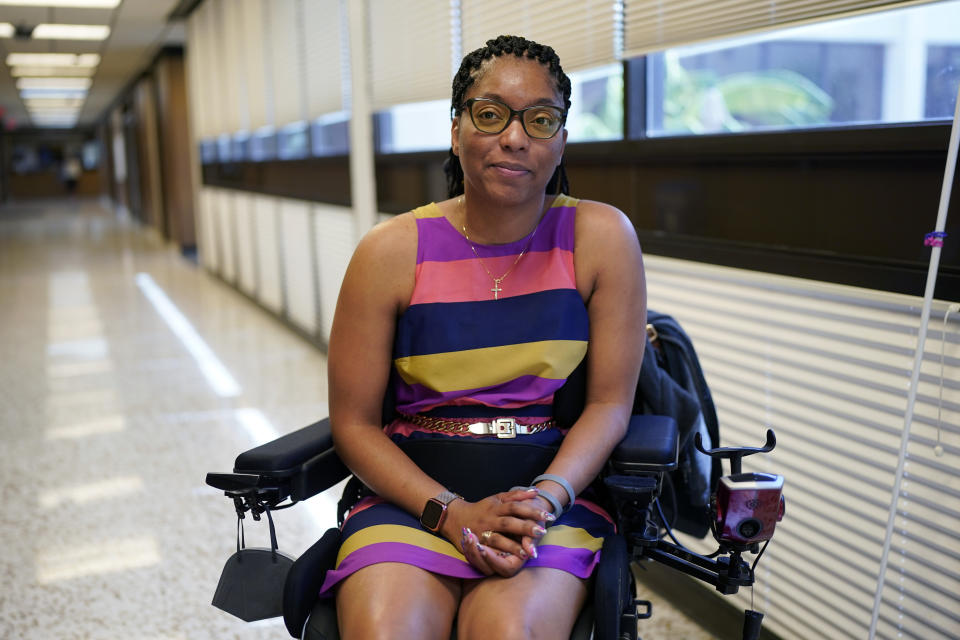 Kimberlyn Barton-Reyes, who is paraplegic and visually impaired, poses for a photo at a rehabilitation center, Wednesday, Aug. 23, 2023, in Austin, Texas. For Barton-Reyes, the Affordable Connectivity Program is a lifeline and its one-time allocation of $14.2 billion is projected to run out by the middle of 2024. That could end access to affordable broadband for her and more than 20 million households. (AP Photo/Eric Gay)