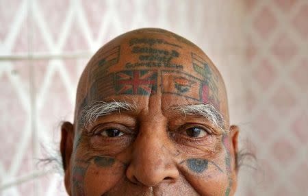 Guinness Rishi, 74, multiple world record holder including most flags tattooed on his body, poses for a photograph outside his apartment in New Delhi, India May 20, 2016. REUTERS/Cathal McNaughton