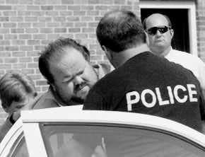 Officials escort murder suspect Alan Eugene Miller of Billingsley, Ala., away from the Pelham City Jail on Thursday. Miller has been charged with three counts of murder in the slayings of three people at two separate businesses in Pelham, Ala. Miller allegedly killed two co-workers at Ferguson Enterprises Inc., before shooting a third person at a company where he used to work. AP photo