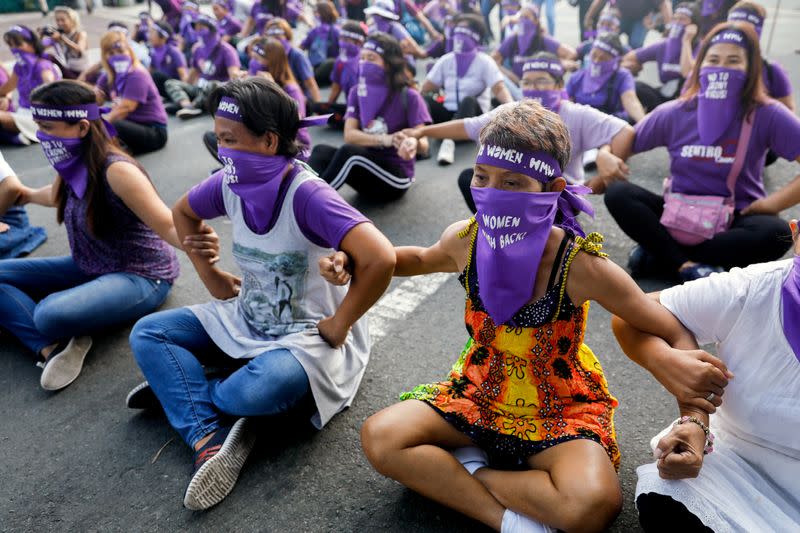 Women occupy a street on International Women's Day in Manila