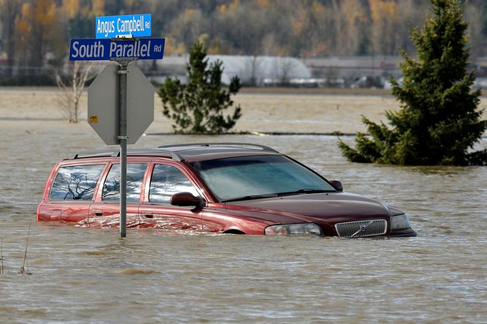 A vehicle is submerged in water after rainstorms caused flooding and landslides in Abbotsford, British Columbia (REUTERS)