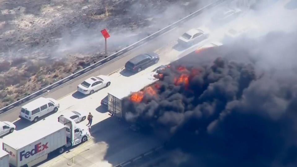 Frame grab from video of cars burning on Interstate 15 during a brush fire in the Cajon Pass, California