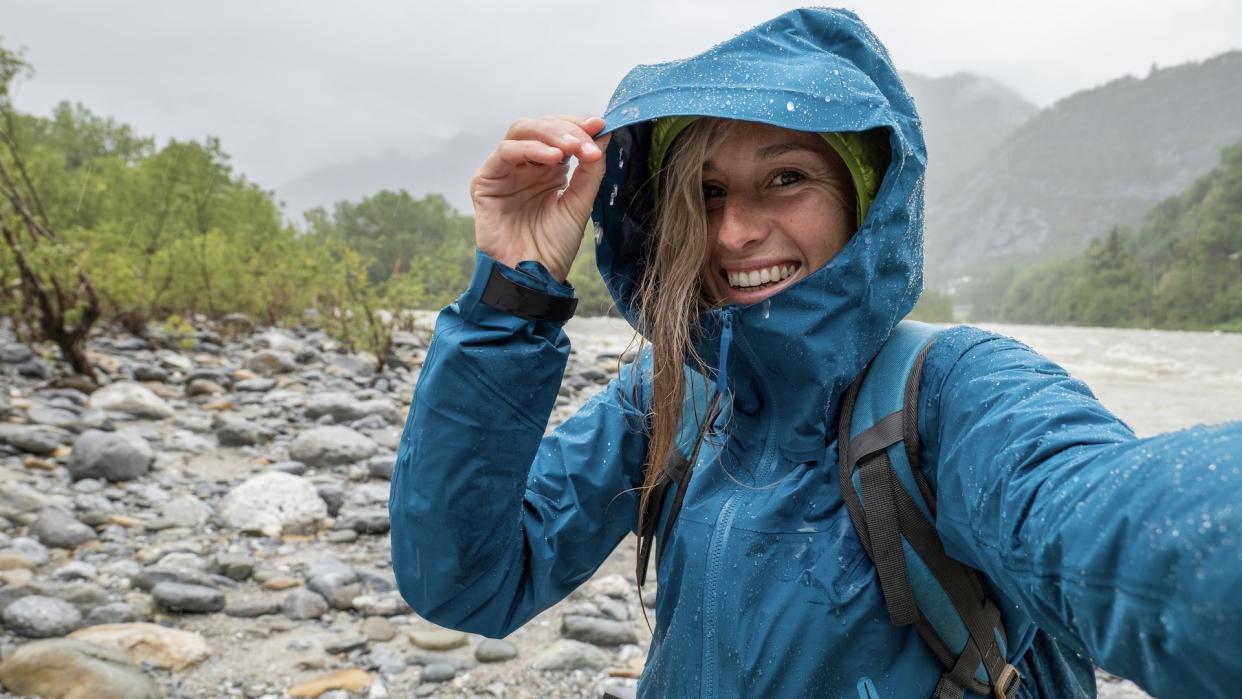  Woman hiking in rain. 