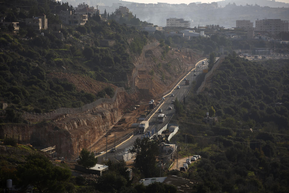 Roadworks expand a road to Israeli settlements inside the West Bank, near the city of Bethlehem, Sunday, Nov. 29, 2020. In years to come, Israelis will be able to commute into Jerusalem and Tel Aviv from settlements deep inside the West Bank via highways, tunnels and overpasses that cut a wide berth around Palestinian towns. Rights groups say the new roads that are being built will set the stage for explosive settlement growth, even if President-elect Joe Biden's administration somehow convinces Israel to curb its housing construction. (AP Photo/Majdi Mohammed)