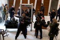 FILE PHOTO: Security personnel check journalists ahead of a news conference to be delivered by former Nissan chairman Carlos Ghosn in Beirut