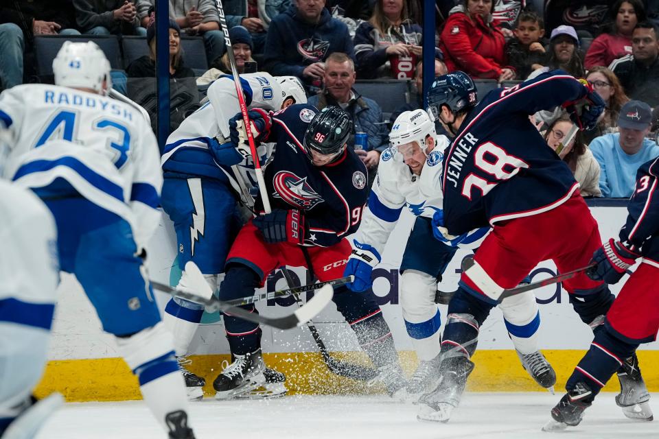 Nov 1, 2023; Columbus, Ohio, USA; Columbus Blue Jackets center Jack Roslovic (96) fights for the puck with Tampa Bay Lightning left wing Nicholas Paul (20) and Tampa Bay Lightning defenseman Calvin de Haan (44) during the third period of the NHL hockey game at Nationwide Arena. The Blue Jackets won 4-2.