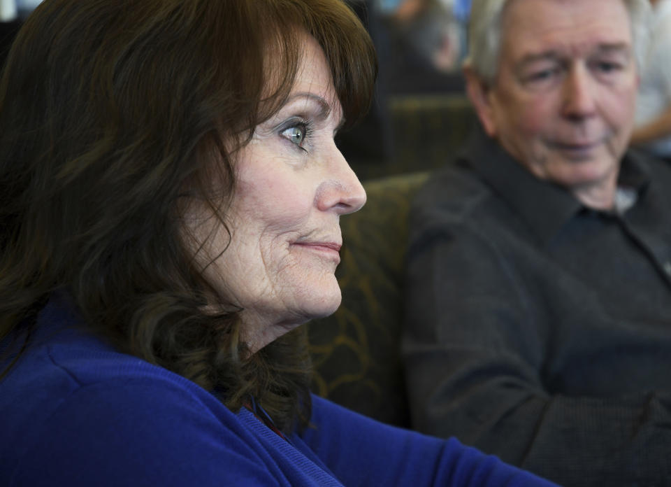 In this Saturday, March 23, 2019 photo, Sandy and Darrell Scott speak about the upcoming 20th anniversary of the mass shooting at Columbine High School in suburban Denver. The Scotts' daughter, Rachel, was killed in the April 20, 1999, attack. Several survivors and family members of the victims gathered at the school's library to speak to the media Saturday. (AP Photo/Thomas Peipert)